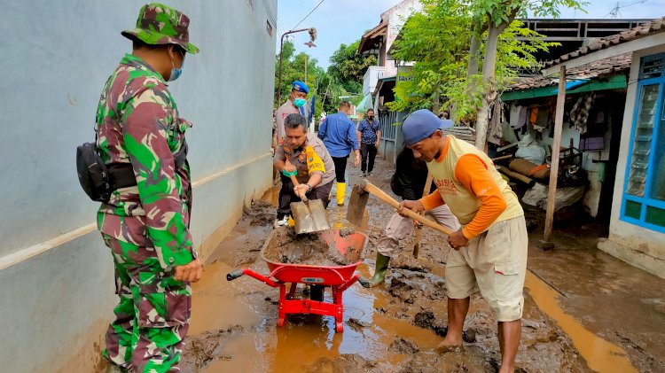 Kapolres dan Personil TNI membersihkan lumpur di rumah warga. /RMOLJatim