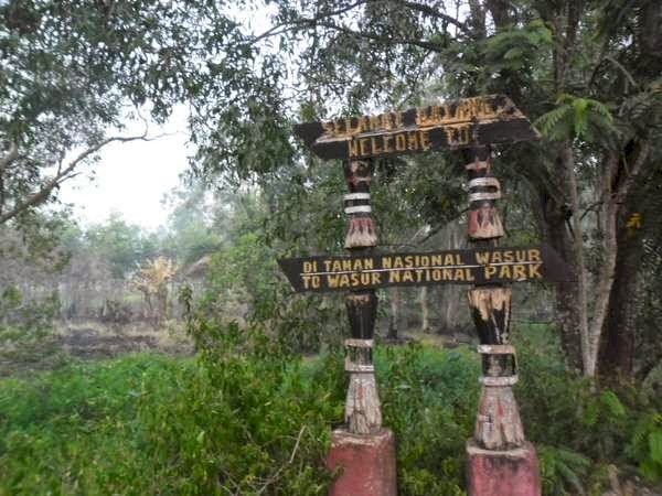 lustrasi Papan Nama Pintu Masuk Taman Nasional Wasur