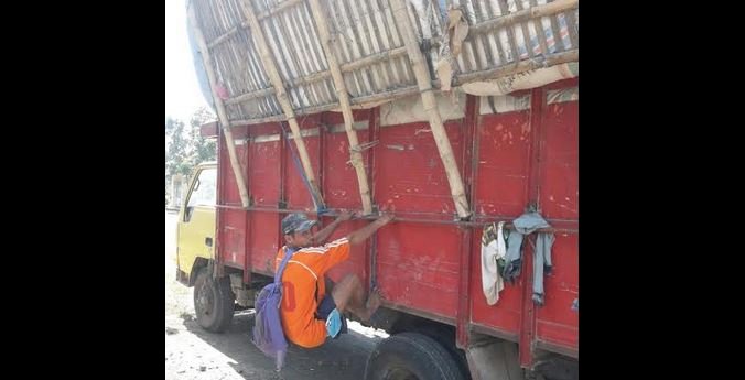 Saksi memperagakan bergelantungan di truk sebagai penyeimbang supaya tidak miring ke kanan/RMOLJatim