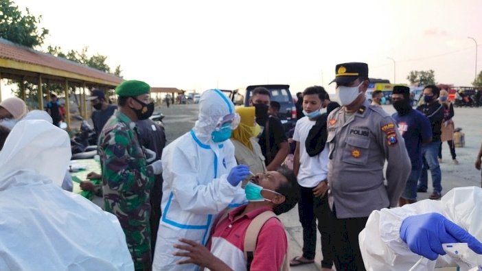 Petugas berpakaian APD lengkap melakukan tes swab antigen bagi penumpang asal pulau Madura/RMOLJatim