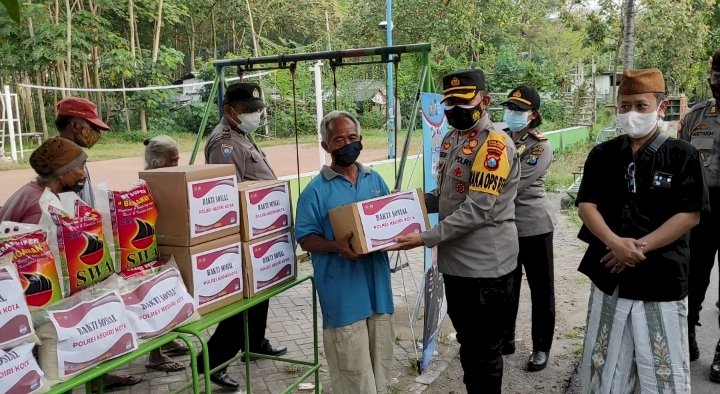 Kompol Teguh Santoso memberikan bantuan paket sembako ke salah satu warga terdampak PPKM Darurat/RMOLJatim