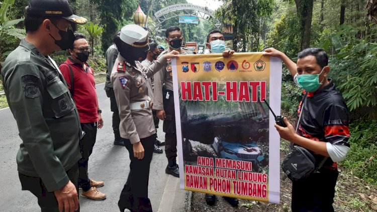 Kasatlantas Polres Jember AKP Enggar  Laufria memasang banner peringatan disepanjang kawasan Gunung Gumitir/RMOLJatim