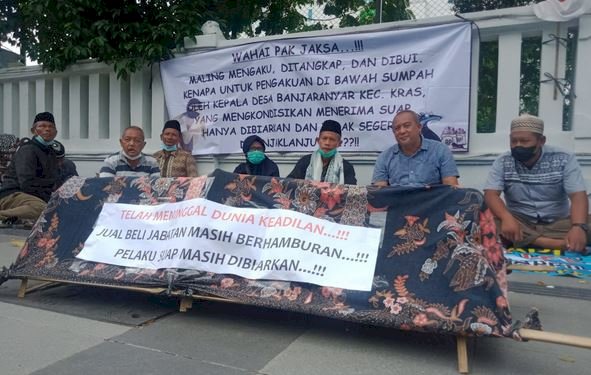 Sambil membawa keranda mayat dan poster, warga Desa Banjaranyar didampingi aktivis Gema Forsak berunjukrasa di depan kantor Kejaksaan Tinggi Jawa Timur, Senin (22/11)/RMOLJatim