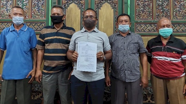 Advokat Ketut Suardana menunjukkan bukti laporan polisi bersama tokoh masyarakat Desa Sawotratap, Sidoarjo/RMOLJatim