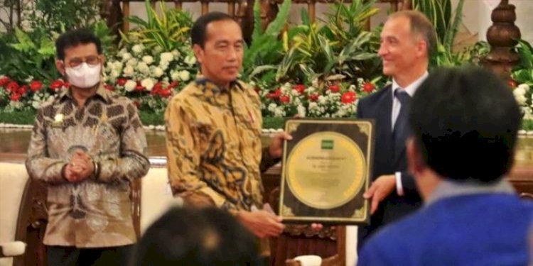 Direktur Jenderal IRRI Jean Balie menyerahkan penghargaan kepada Presiden Jokowi karena berhasil melakukan swasembada beras di Istana Negara/Ist