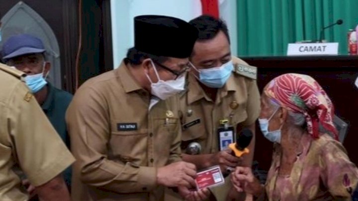 Wali Kota Malang Drs. H. Sutiaji (tengah) memakai peci hitam saat membagikan Santunan terhadap warga yang tidak mampu/Ist