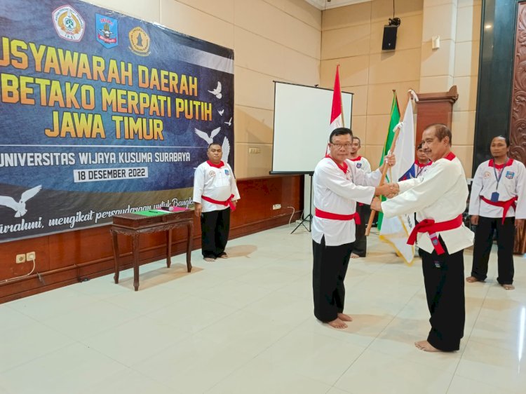 Ketua Umum PP Merpati Putih Brigjen Pol Leo Bona Lubis saat menyerahkan Pataka kepada Ketua terpilih Pengda PPS Betako Merpati Putih Jatim Harryanto BS Soenaryo/ist