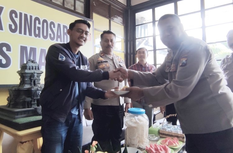   Jajaran Polisi Sektor Singosari saat menyerahkan potongan tumpeng pertama terhadap perwakilan jurnalis televisi, Rafli/RMOLJatim