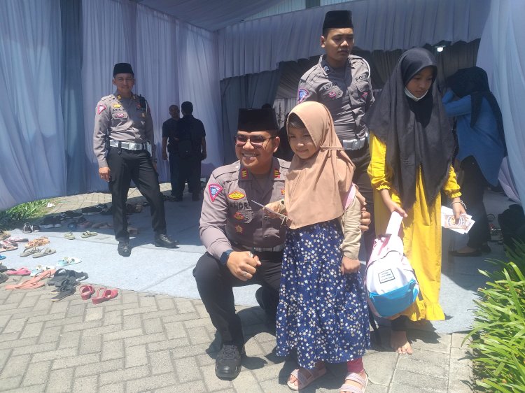 Satlantas Polres Probolinggo Kota bersama salah satu anak yatim/Ist