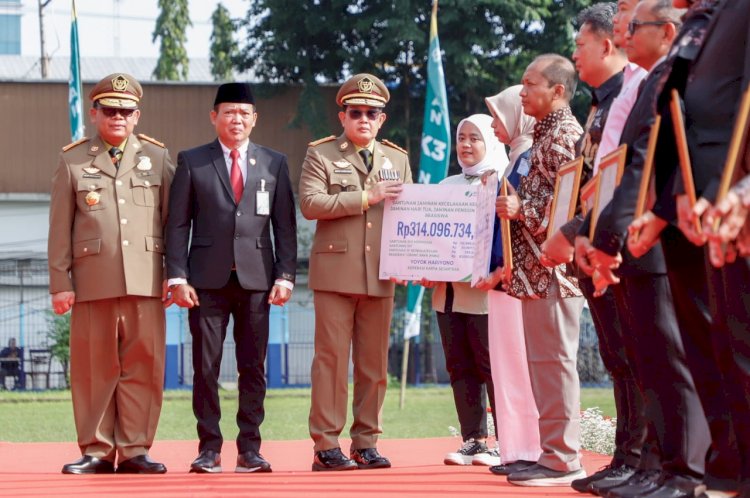 Pj Gubernur Jatim Adhy Karyono menyerahkan santunan jaminan kematian dan beasiswa BPJS Ketenagakerjaan usai memimpin apel bulan K3 Nasional 2025/ist